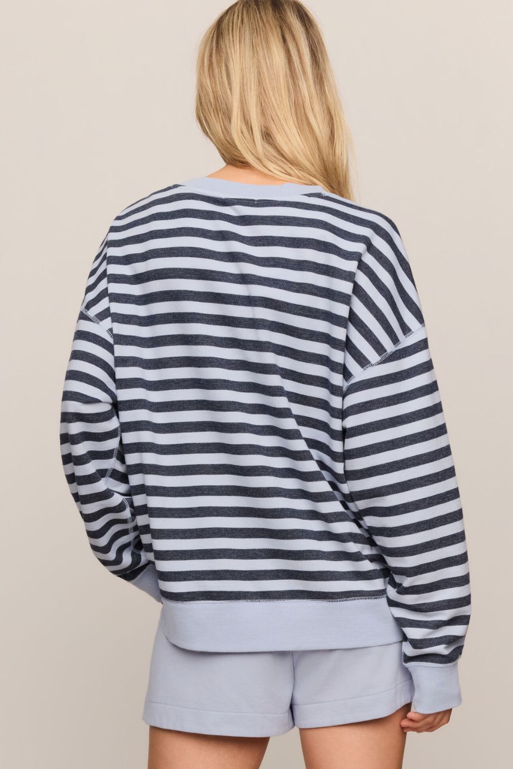 woman in striped blue sweater on a white background
