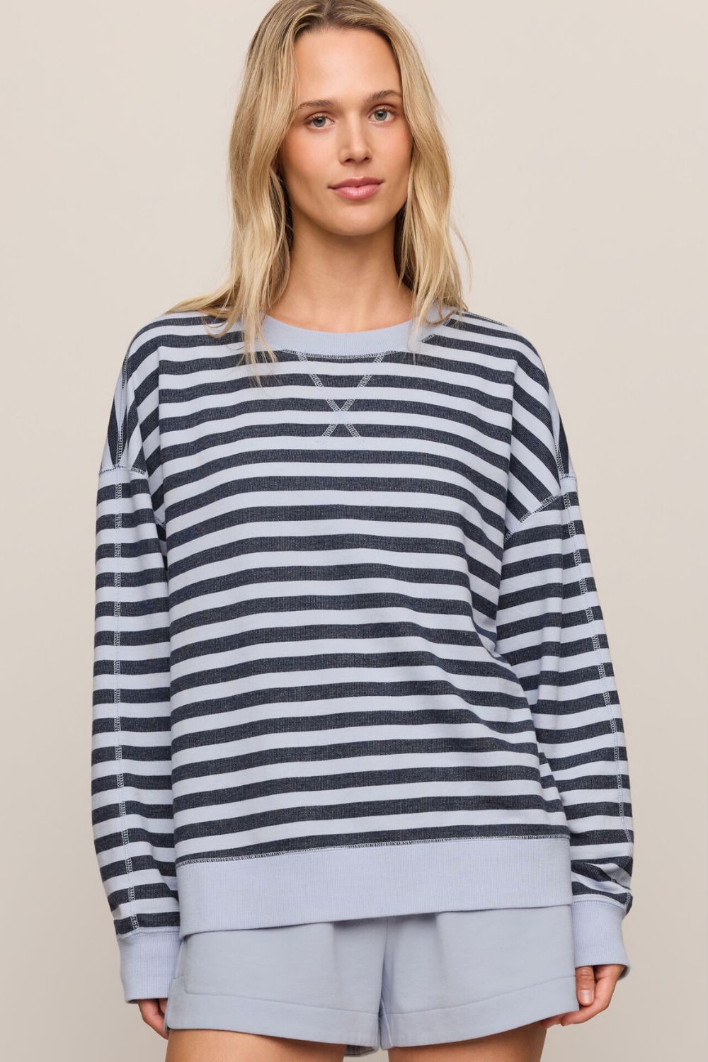woman in striped blue sweater on a white background