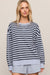 woman in striped blue sweater on a white background