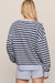 woman in striped blue sweater on a white background