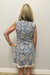 Woman wearing light blue dress with lace embroidered detail in cream