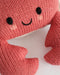 Close-up of the smiling knit face on a coral crab