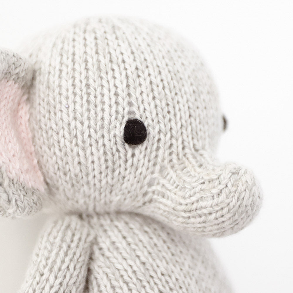 Close-up of the hand-knit stitching on a gray elephant stuffed animal