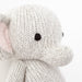 Close-up of the hand-knit stitching on a gray elephant stuffed animal
