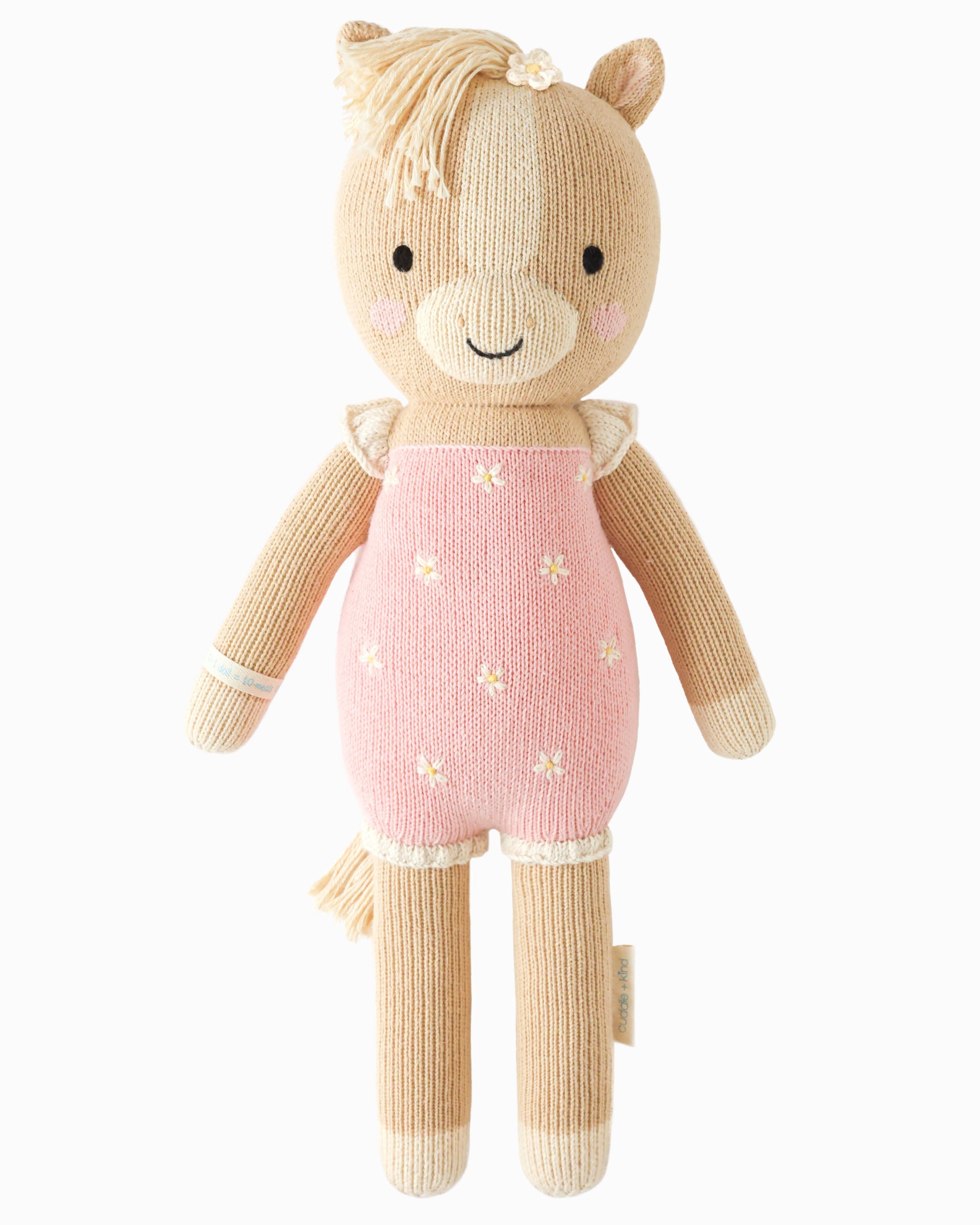 Hand-knit cream pony doll in a pink dress with tiny flowers, front view