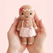 Small hand-knit gingerbread girl doll held in two hands