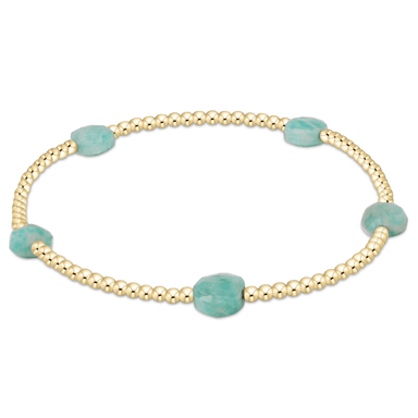 Gold bracelet with turquoise beads on a white background