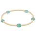 Gold bracelet with turquoise beads on a white background
