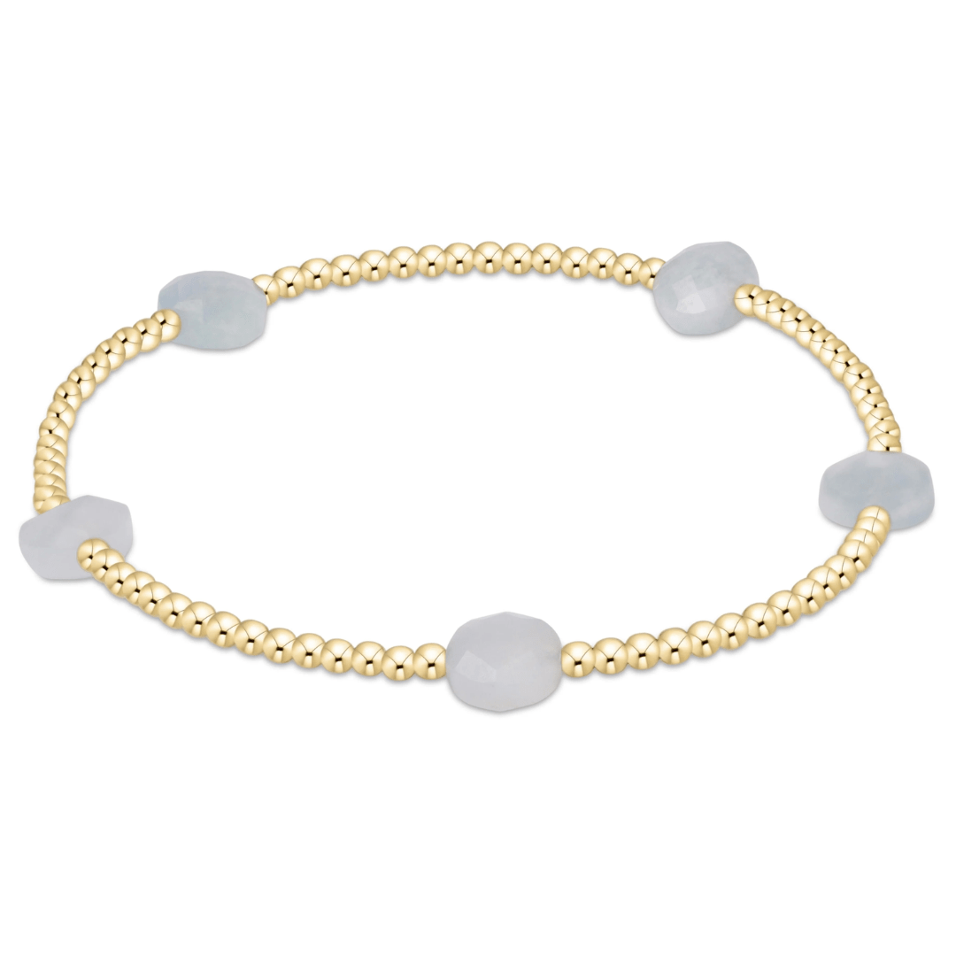 Gold bracelet with gray beads on a white background