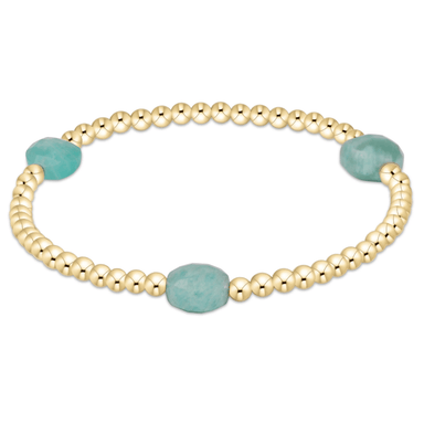 Gold bracelet with turquoise beads on a white background