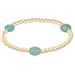 Gold bracelet with turquoise beads on a white background