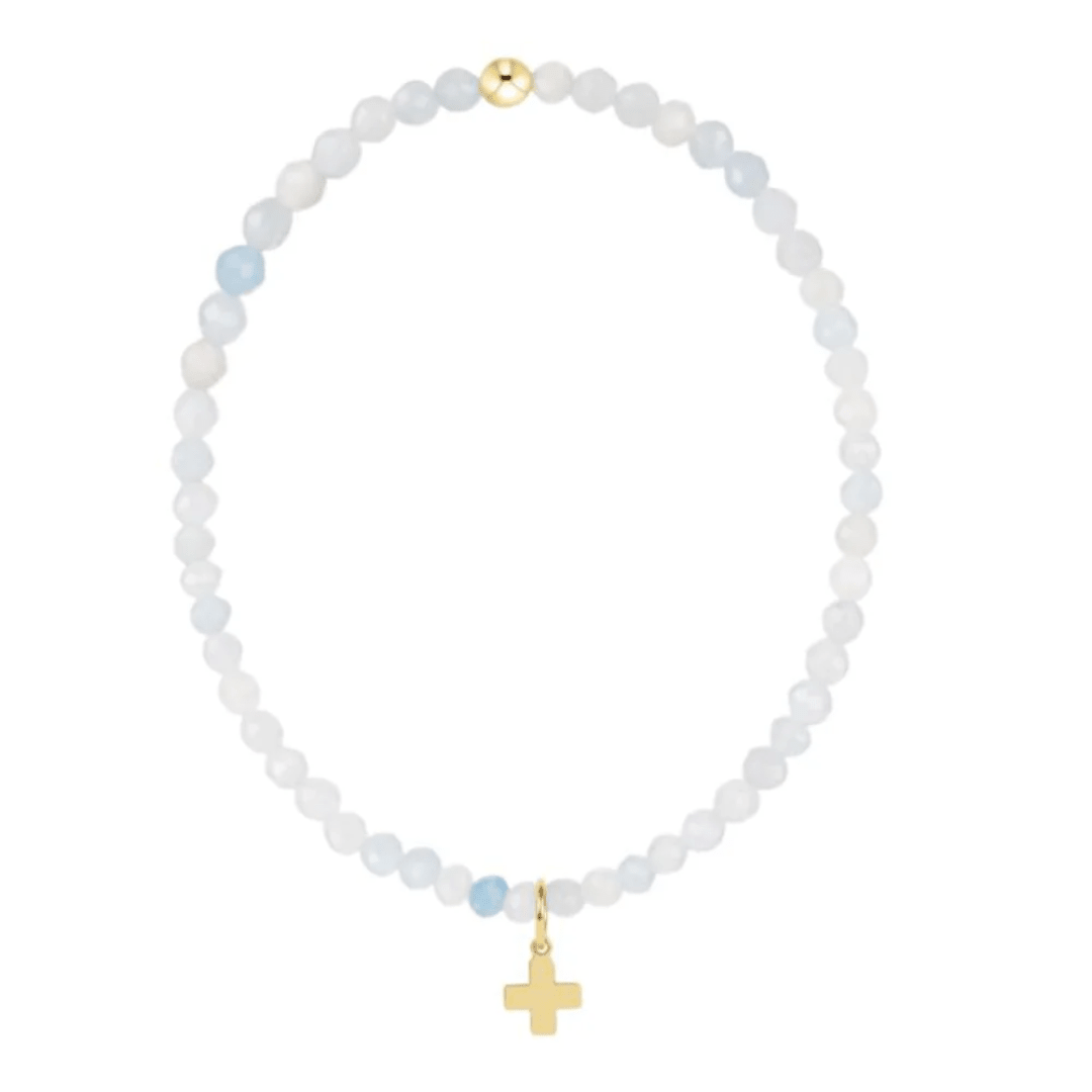 Necklace with white beads and gold cross on a white background