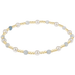 Pearl and gold beaded bracelet on a white background