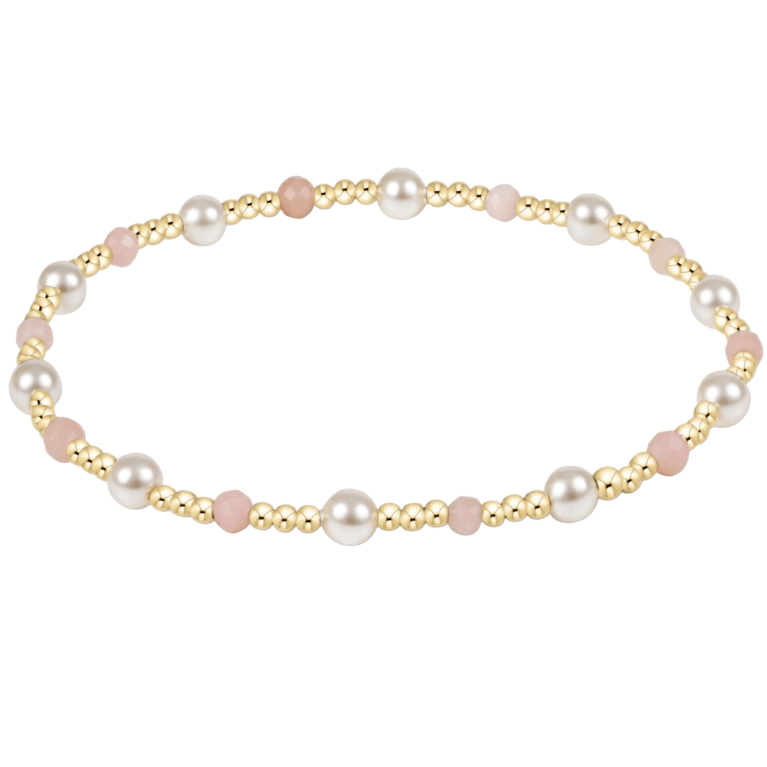 Pearl and gold beaded bracelet on a white background
