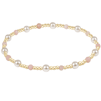 Pearl and gold beaded bracelet on a white background