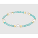 Bracelet with turquoise beads, gold accents, and pearls on a light gray background