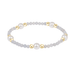 Bracelet with white and gold beads on a white background