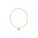 Gold bracelet with a clear pendant on a white background