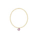 Gold bracelet with a pink pendant on a white background