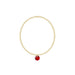 Gold bracelet with a red pendant on a white background