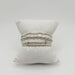 Four sterling silver and pearl bracelets on a white pillow with small silver crosses