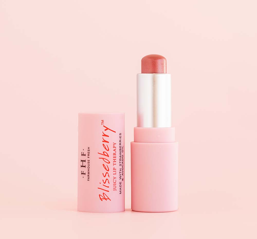 Pink tinted lip balm tube with the cap off