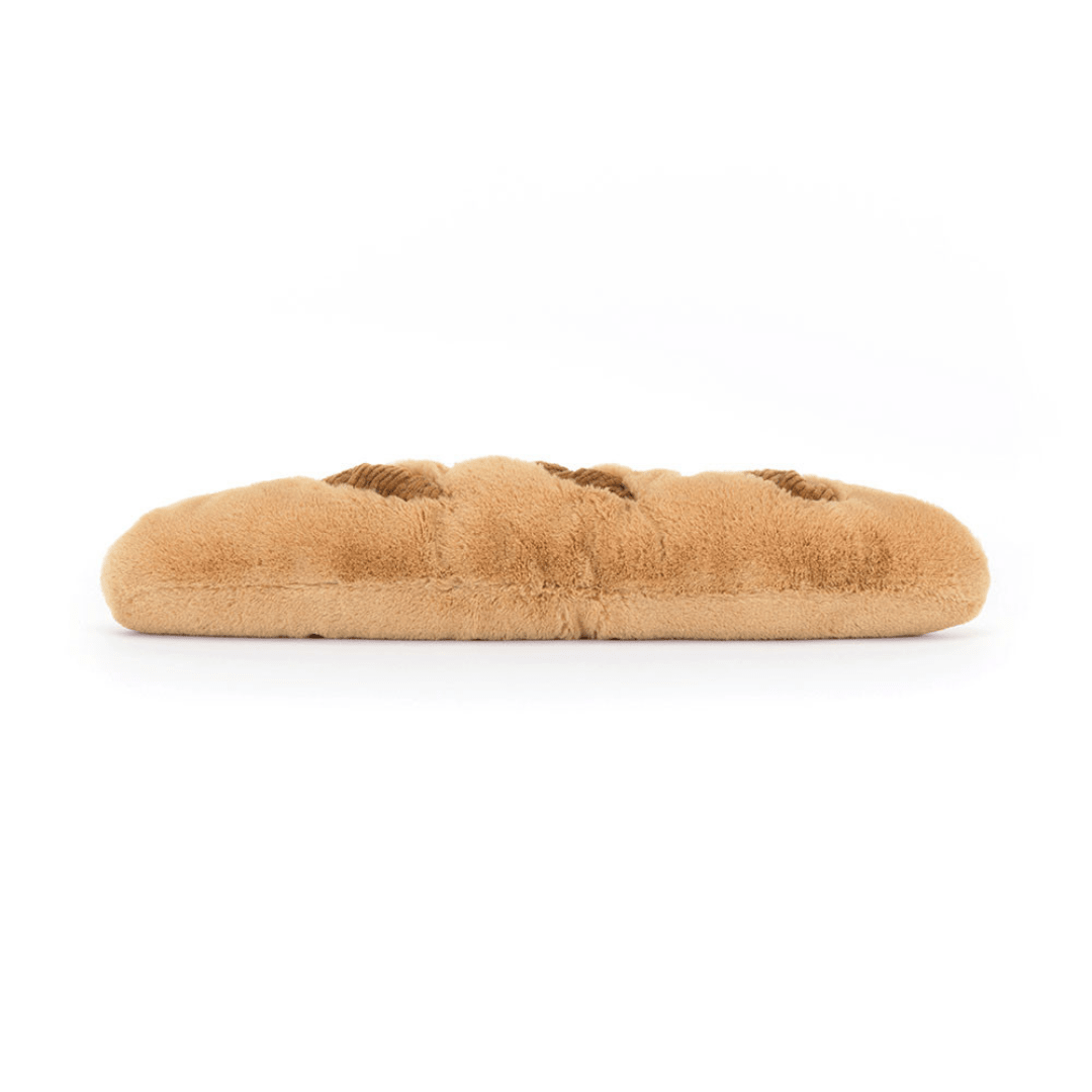 Long rectangular bread loaf stuffed animal on a white background
