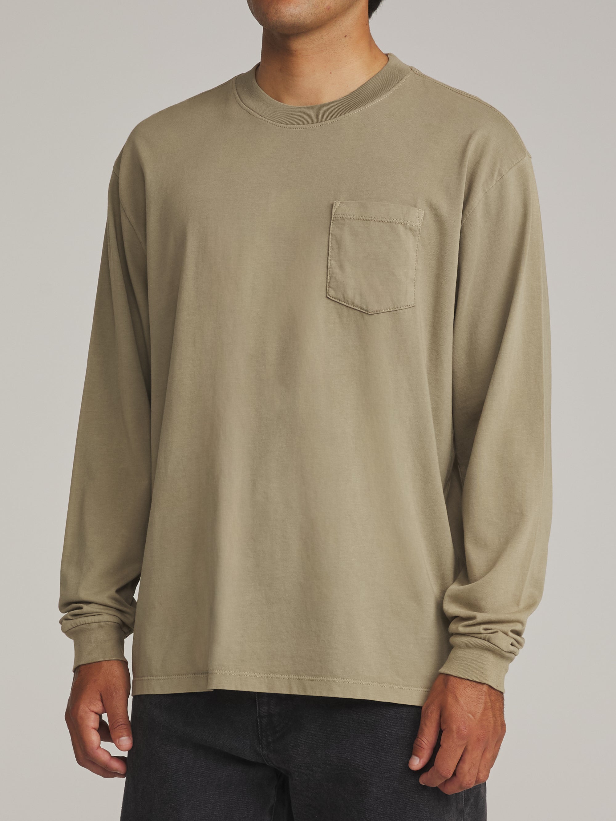 Man wearing the washed olive green Katin Base long sleeve tee, side view