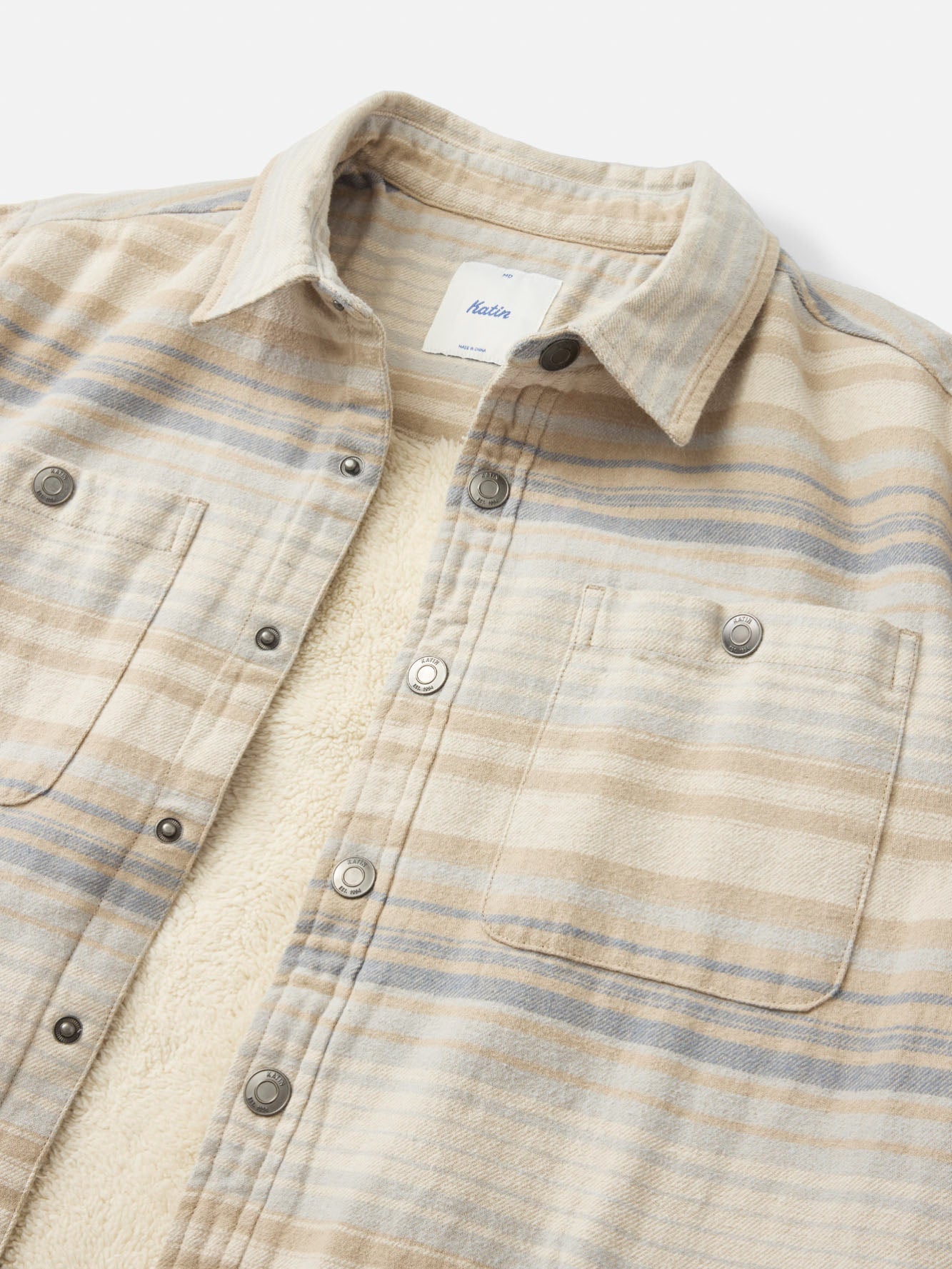 Close-up of the sand striped flannel and cream sherpa lining on the Katin Harold shirt jacket