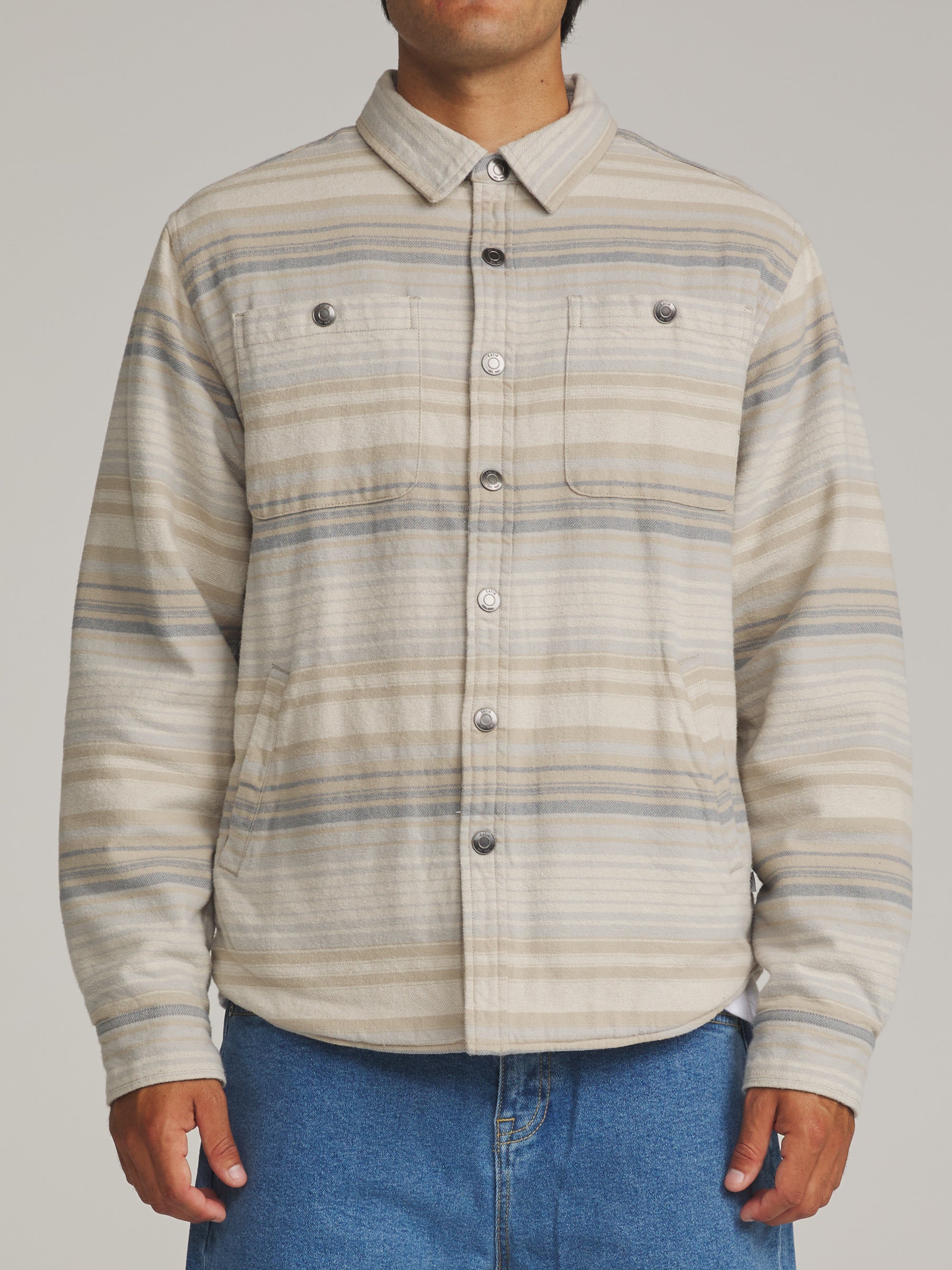 Man wearing the sand striped Katin Harold shirt jacket open over a shirt, front view