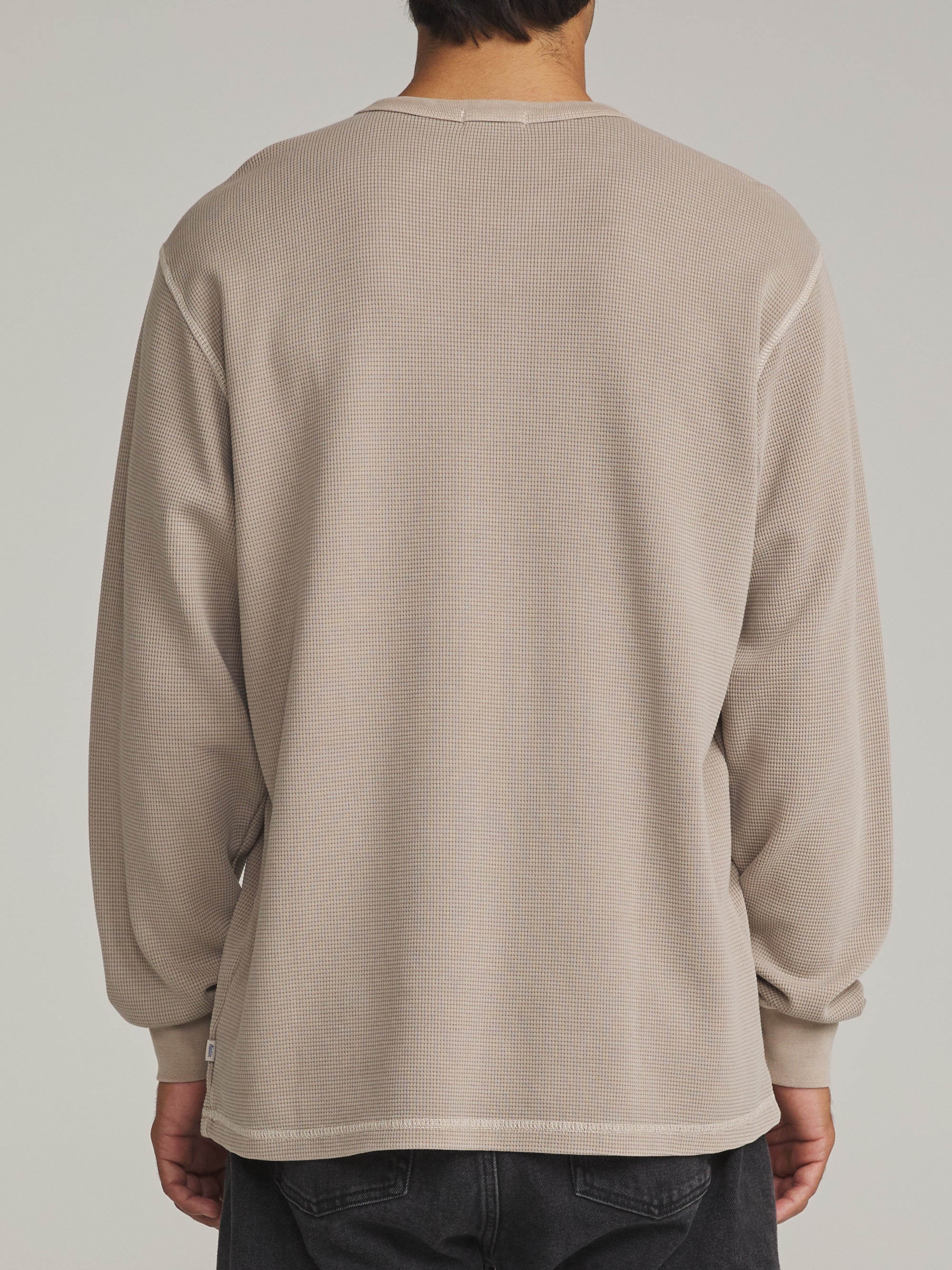 Back view of the washed taupe Katin Mesa waffle knit henley on a model