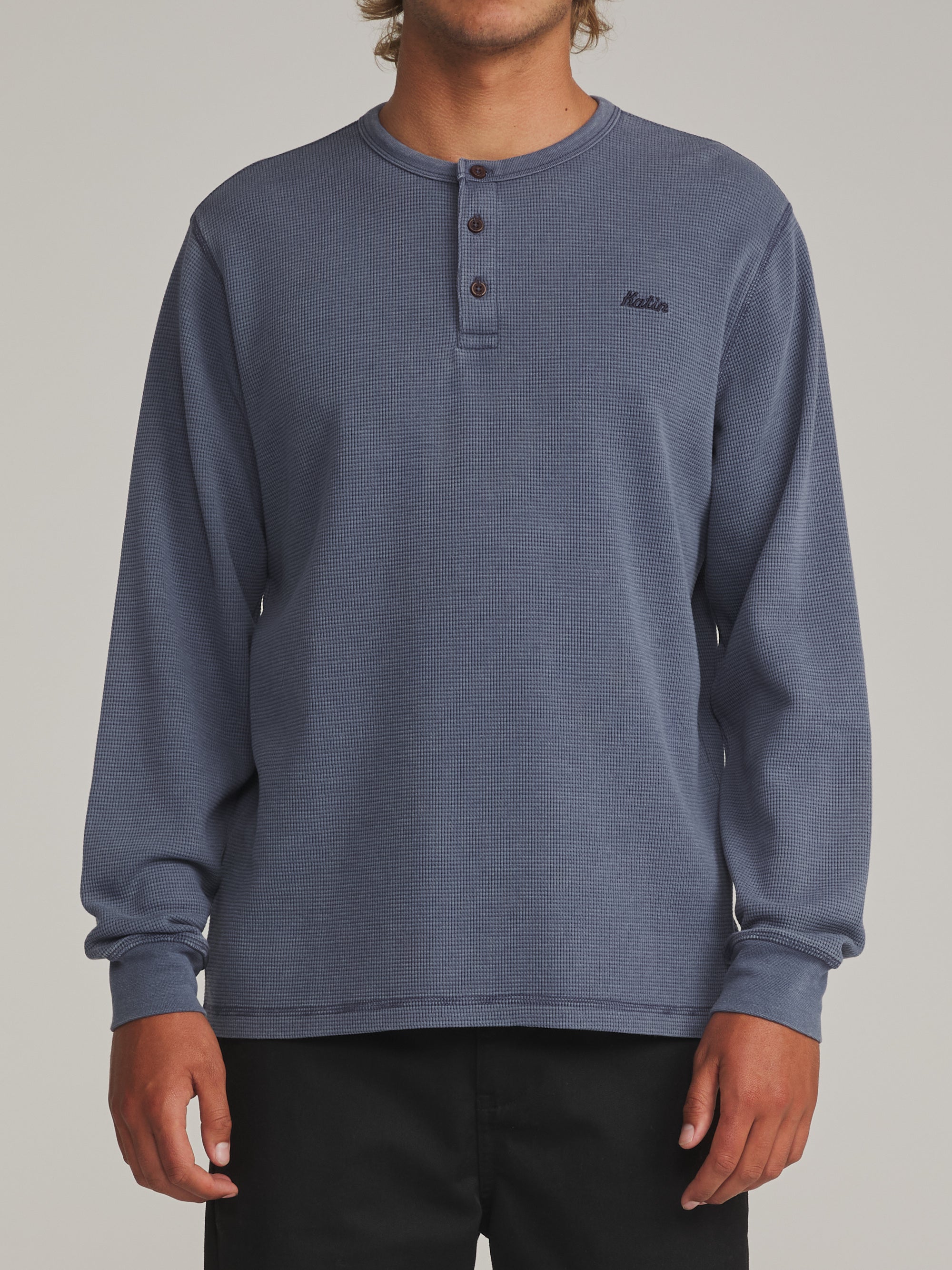 Man wearing the faded blue Katin Mesa waffle knit henley, front view