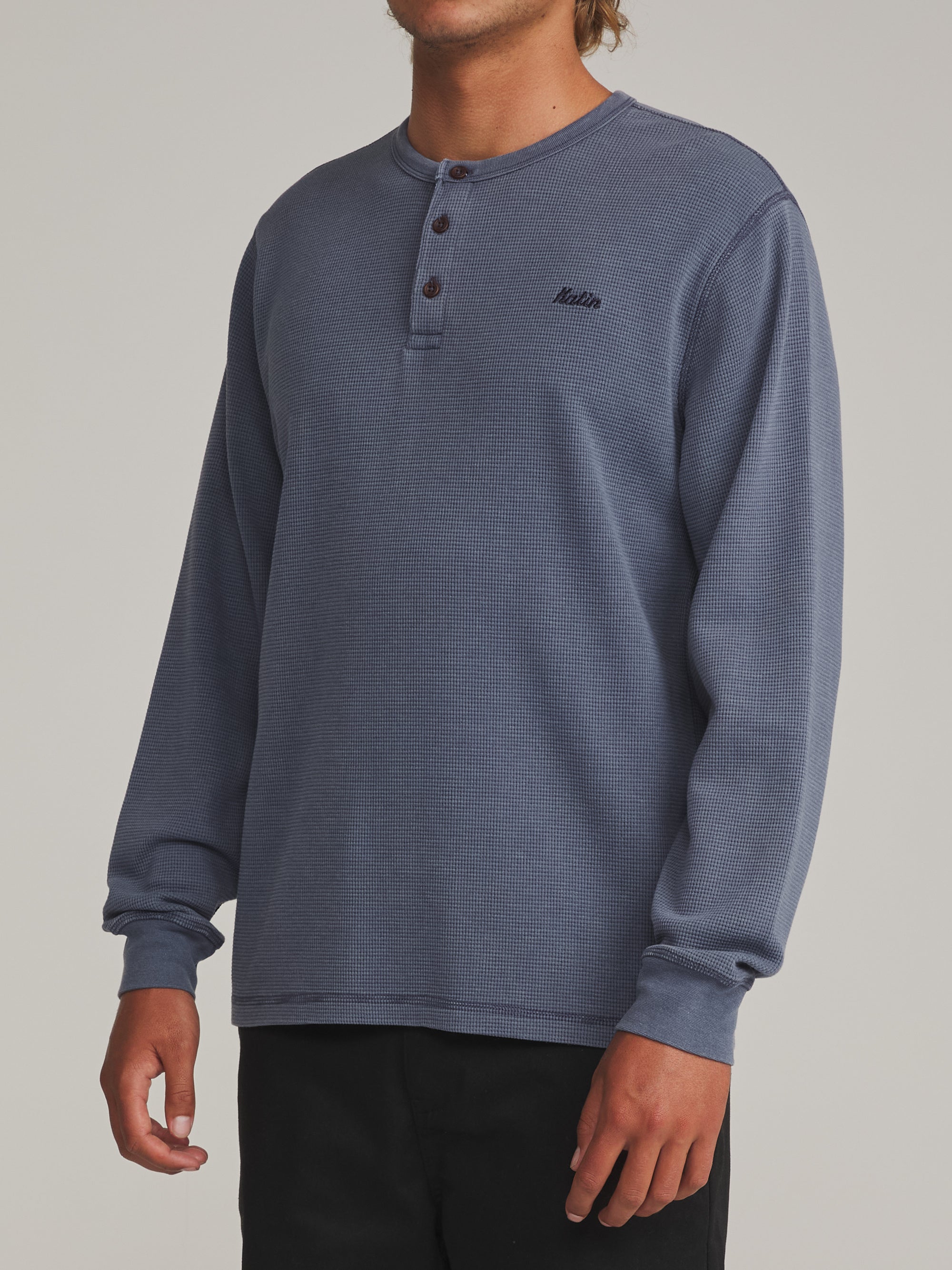 Man wearing the faded blue Katin Mesa waffle knit henley, side view