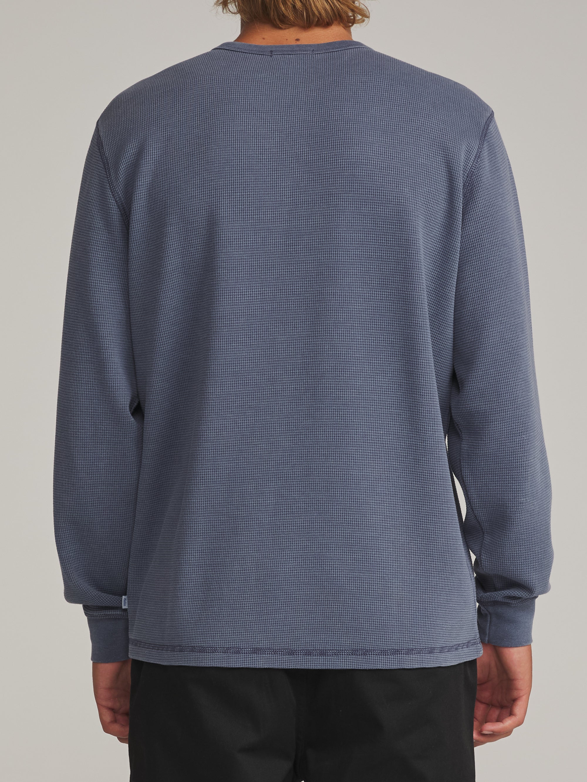 Back view of the faded blue Katin Mesa waffle knit henley on a model
