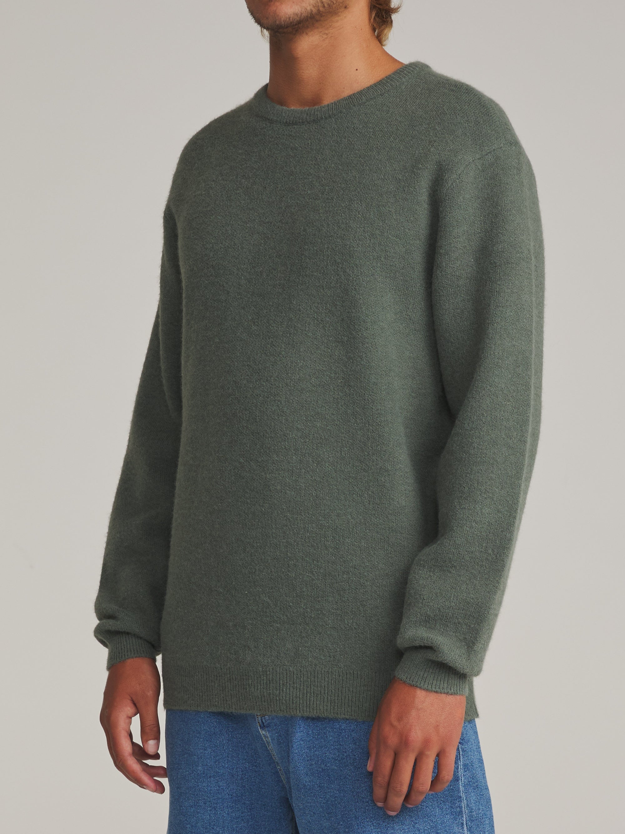 Man wearing the gray green Katin Rivers crew neck sweater, side view