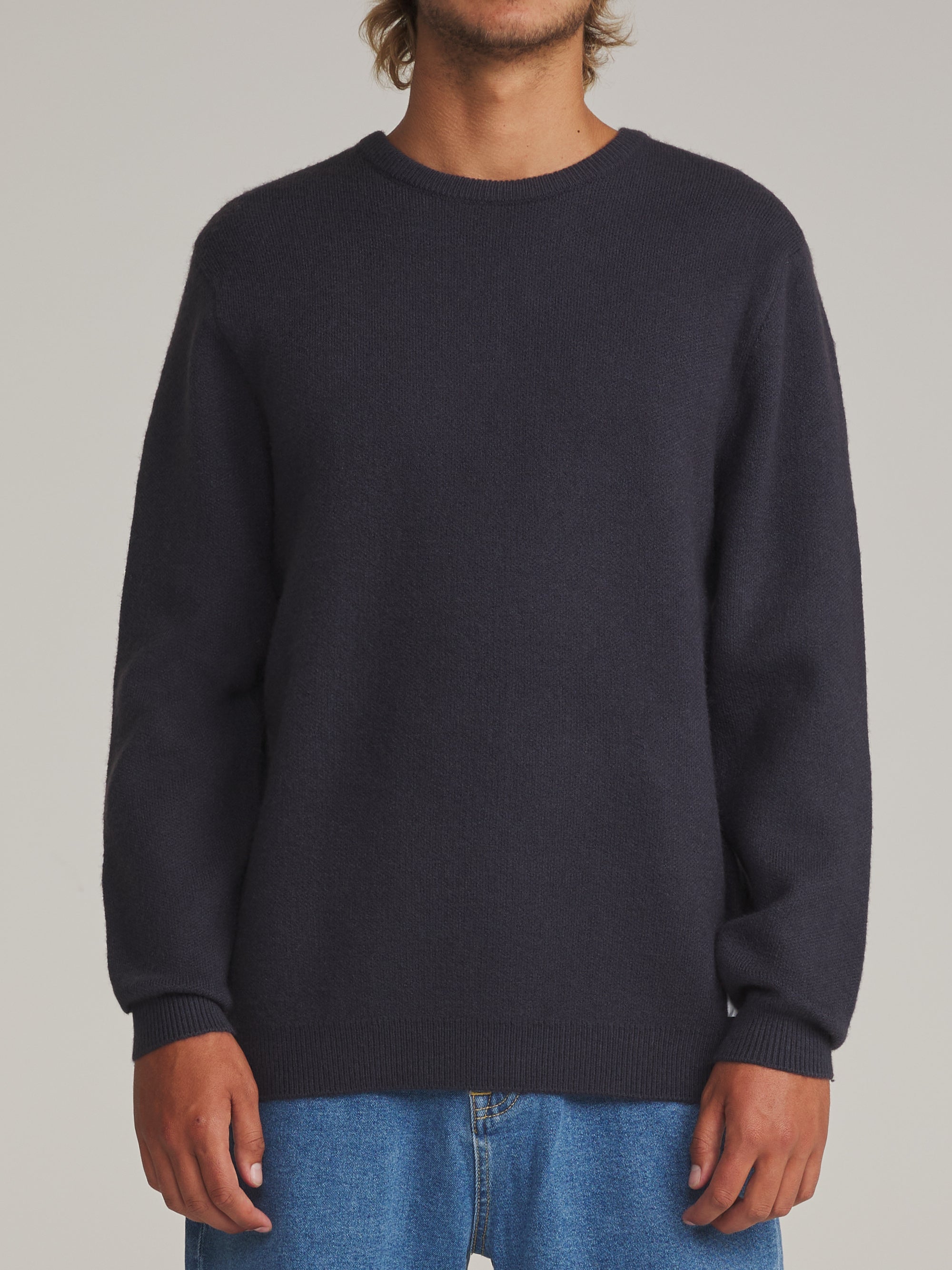Man wearing the navy Katin Rivers crew neck sweater, front view
