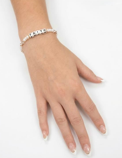 Model wearing the Little Words Project Faith bracelet in pearls and crystals