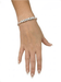 Model wearing the Little Words Project Fearless bracelet in peach and blush crystals