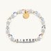 Seafoam and clear bead bracelet spelling Sister with a gold tag