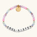 Pink and lavender bead bracelet spelling Soul Sister with a gold tag