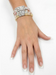 Model wearing a stack of six Little Words Project word bracelets