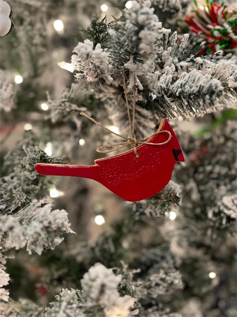 Red cardinal ornament hanging on a Christmas tree