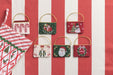 Needlepoint gift card pouches on a red and white striped background