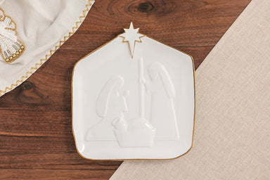 Gold edge Nativity platter on a wood surface