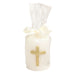 White pillar candle with a gold cross, wrapped in cello with a bow