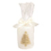 White pillar candle with a gold tree, wrapped in cello with a bow