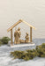 Gold Nativity display styled with holiday greenery