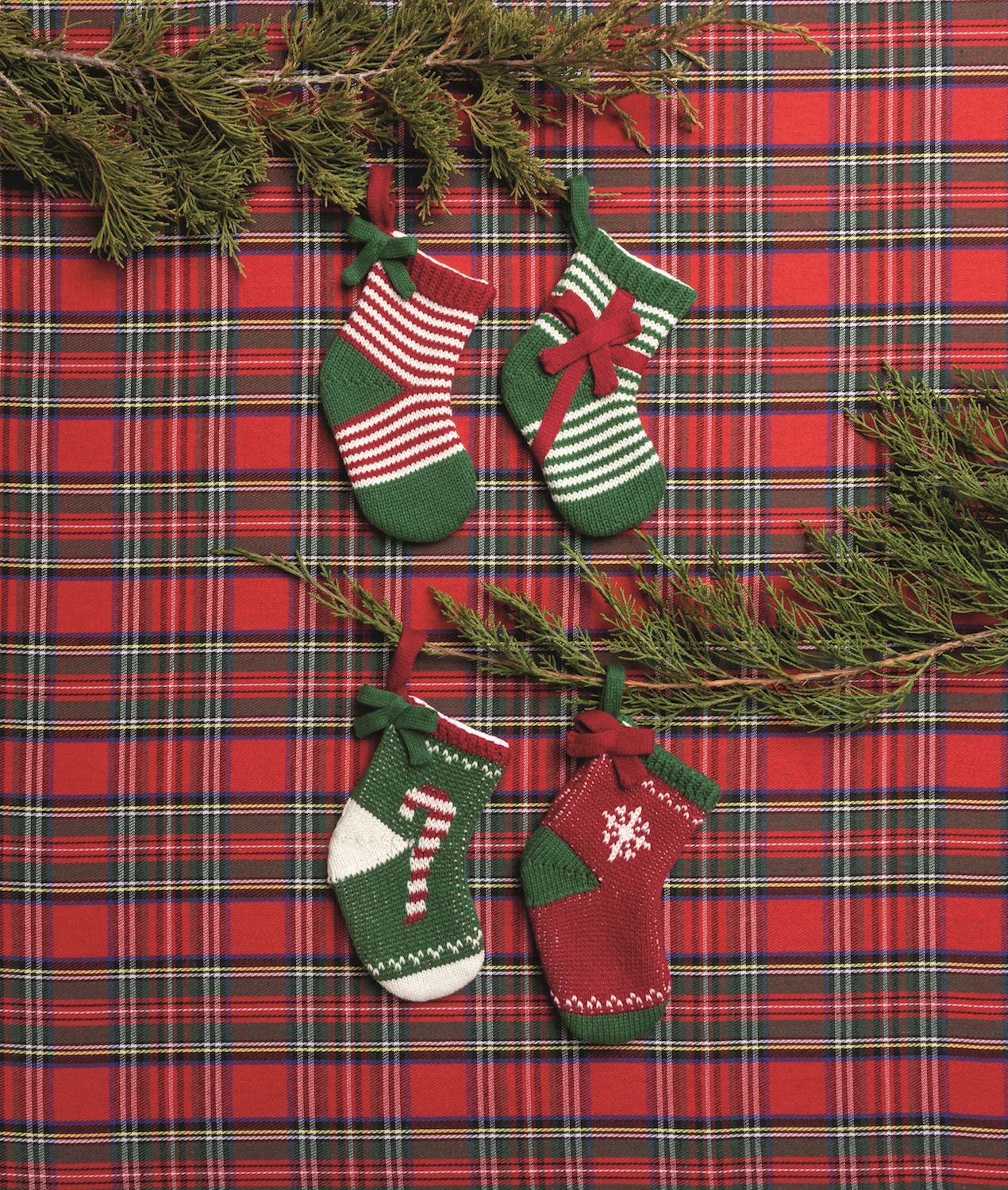 Mini knit stockings on a red tartan background