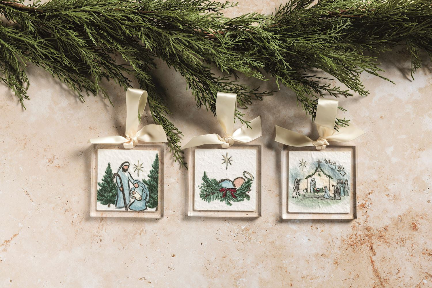 Nativity acrylic ornaments hanging with greenery