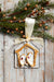 Oyster Nativity ornament hanging with greenery